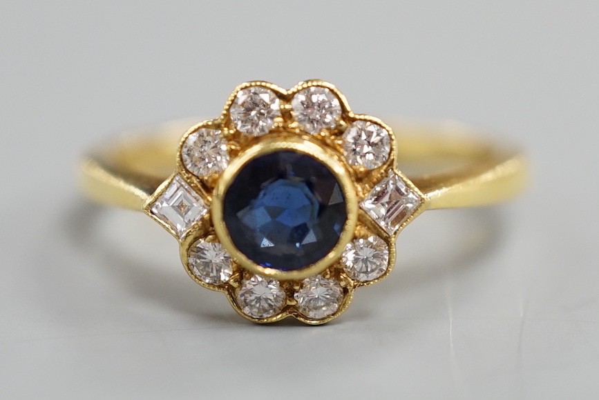 A modern 18ct gold, collet set sapphire and diamond set circular cluster ring, size O, gross weight 3.6 grams